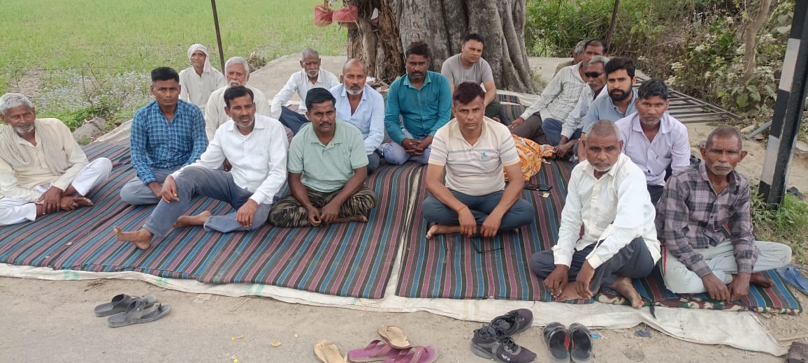 Villagers stage a sit-in protest against the coal depot.