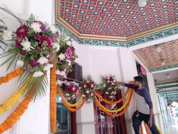 देवी मंदिर में फूलों से दरबार को सजाते कलाकार। संवाद