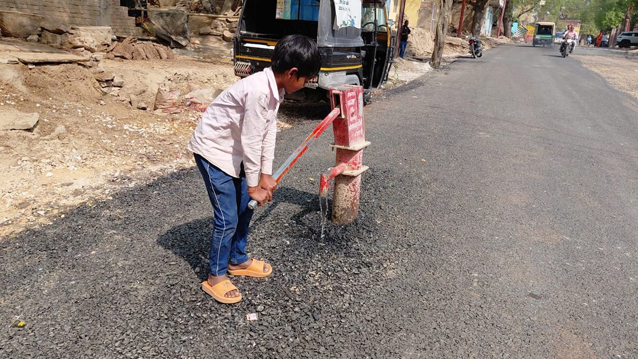 The municipality did not remove the working hand pump, the PWD made the road without shifting it.