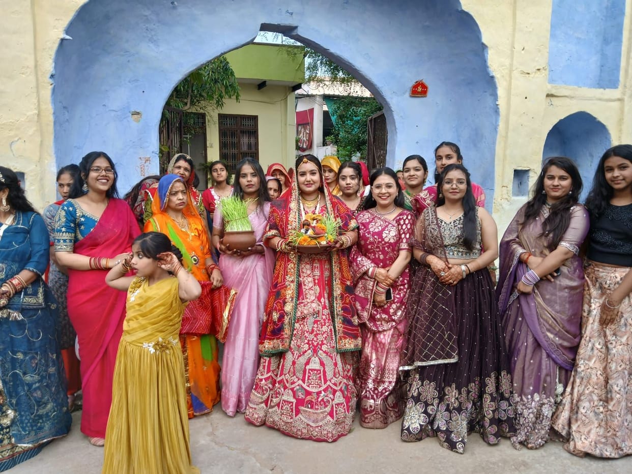 Women immersed Gangaur idols