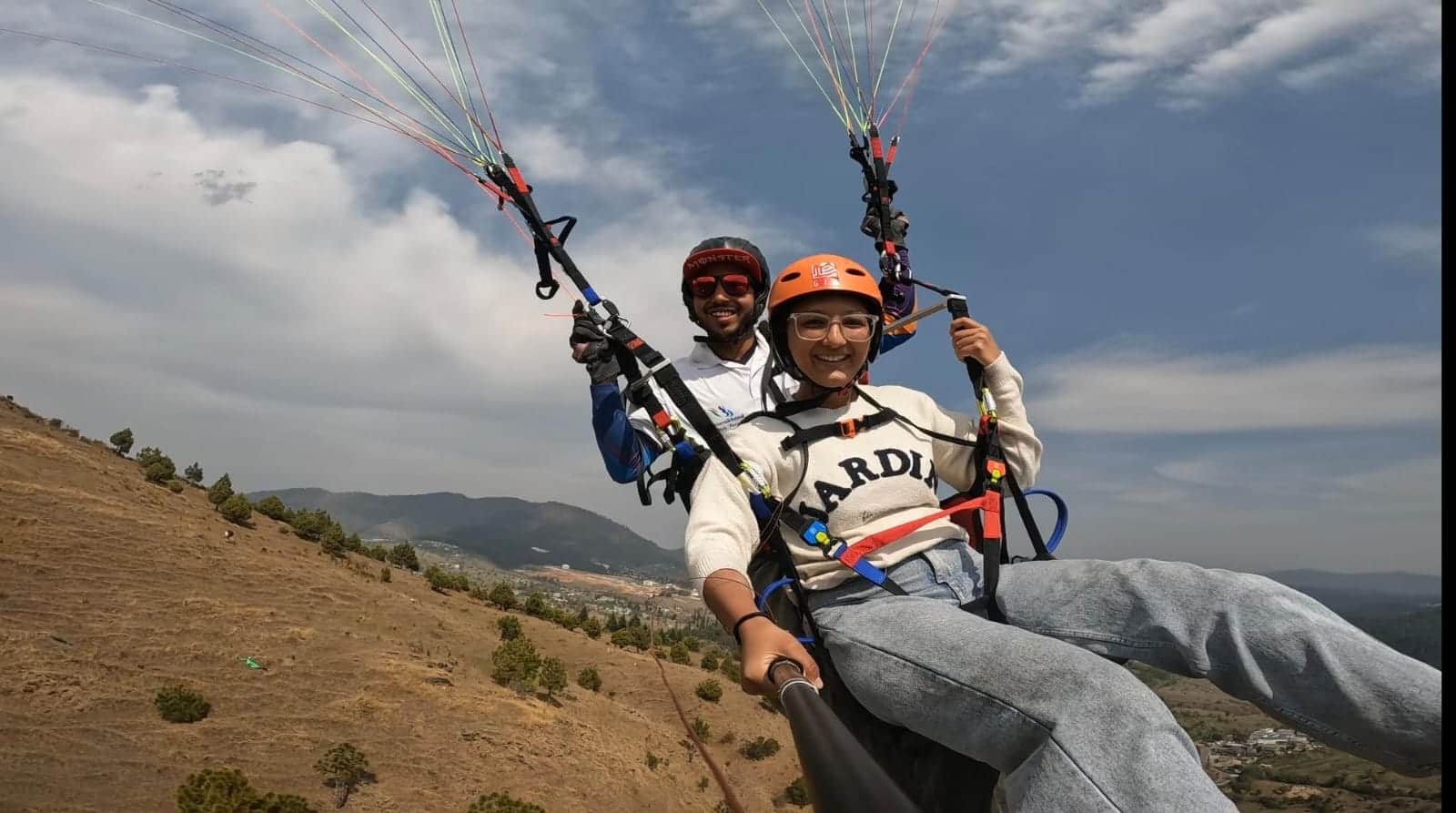 लोहाघाट के बाणासुर किला क्षेत्र में टैंडम पैराग्लाइडिंग करती स्थानीय युवती। स्रोत : संघ