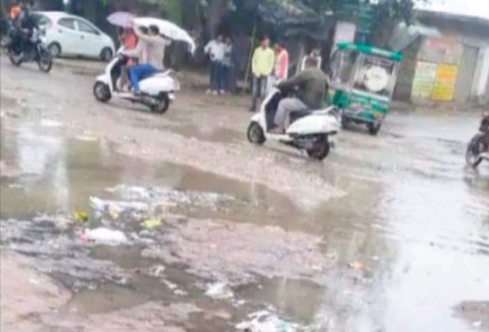 The road near Hasanpur Kadim has broken down and turned into potholes.