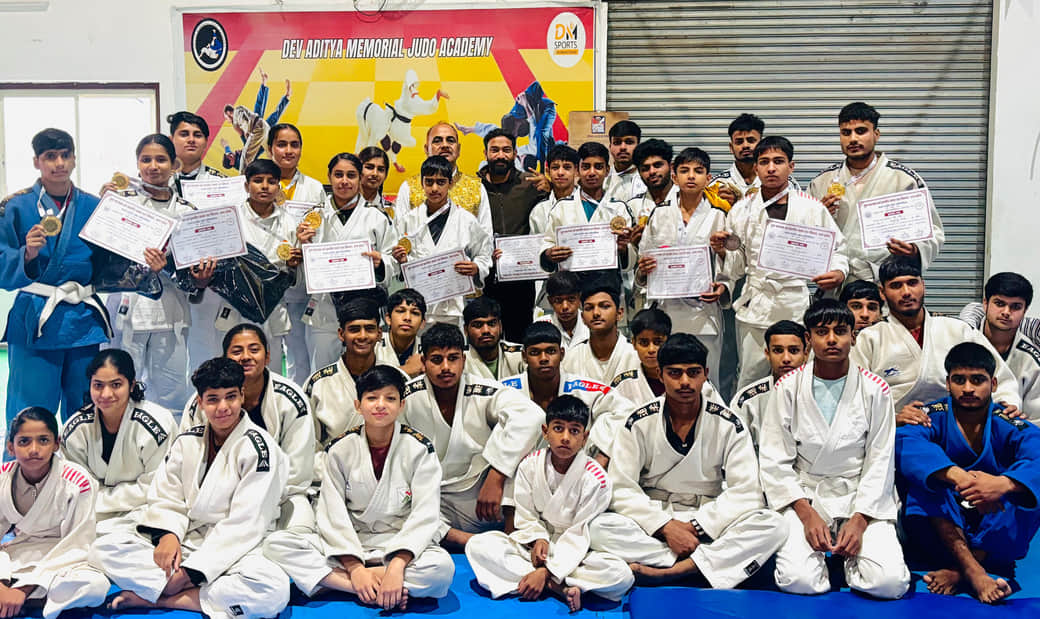 देव-आदित्य मेमोरियल अकादमी में जूडो के पदक विजेता खिलाड़ियों को सम्मानित करते प्रशिक्षक व शिक्षक