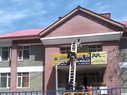 A woman lost her balance and fell on the roof of a police station.