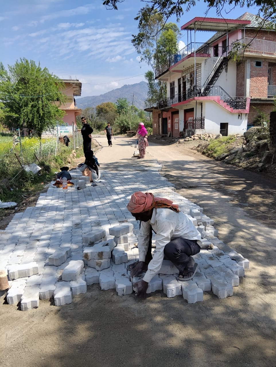 Work on laying cement paver blocks on the road has begun.