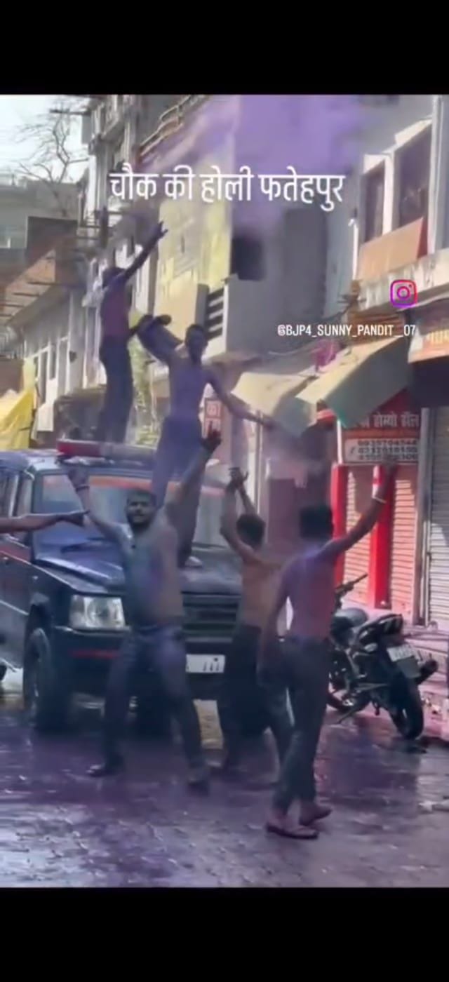 Friends danced on a government jeep in front of a policeman.
