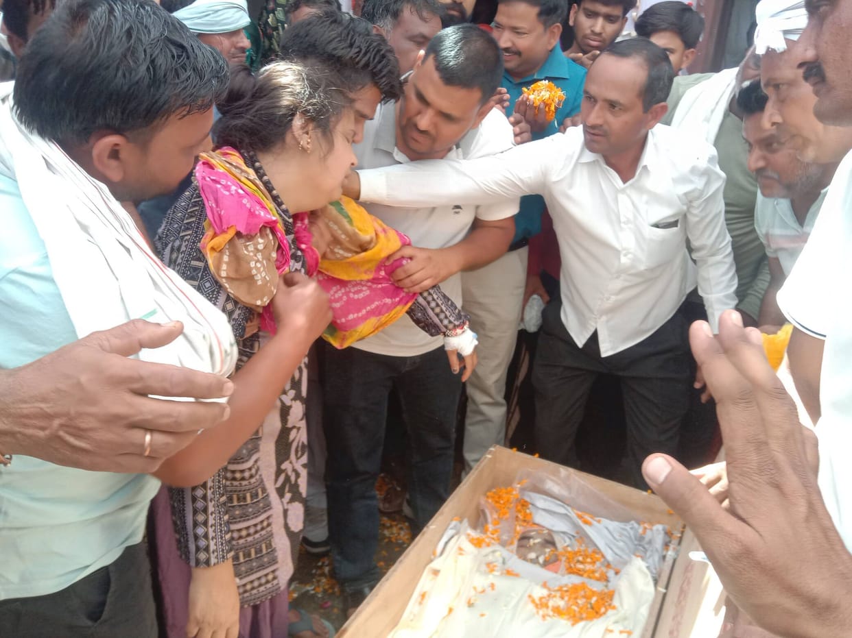 Seeing the body of husband Rajesh, his wife broke down and bid him farewell with a shower of flowers.