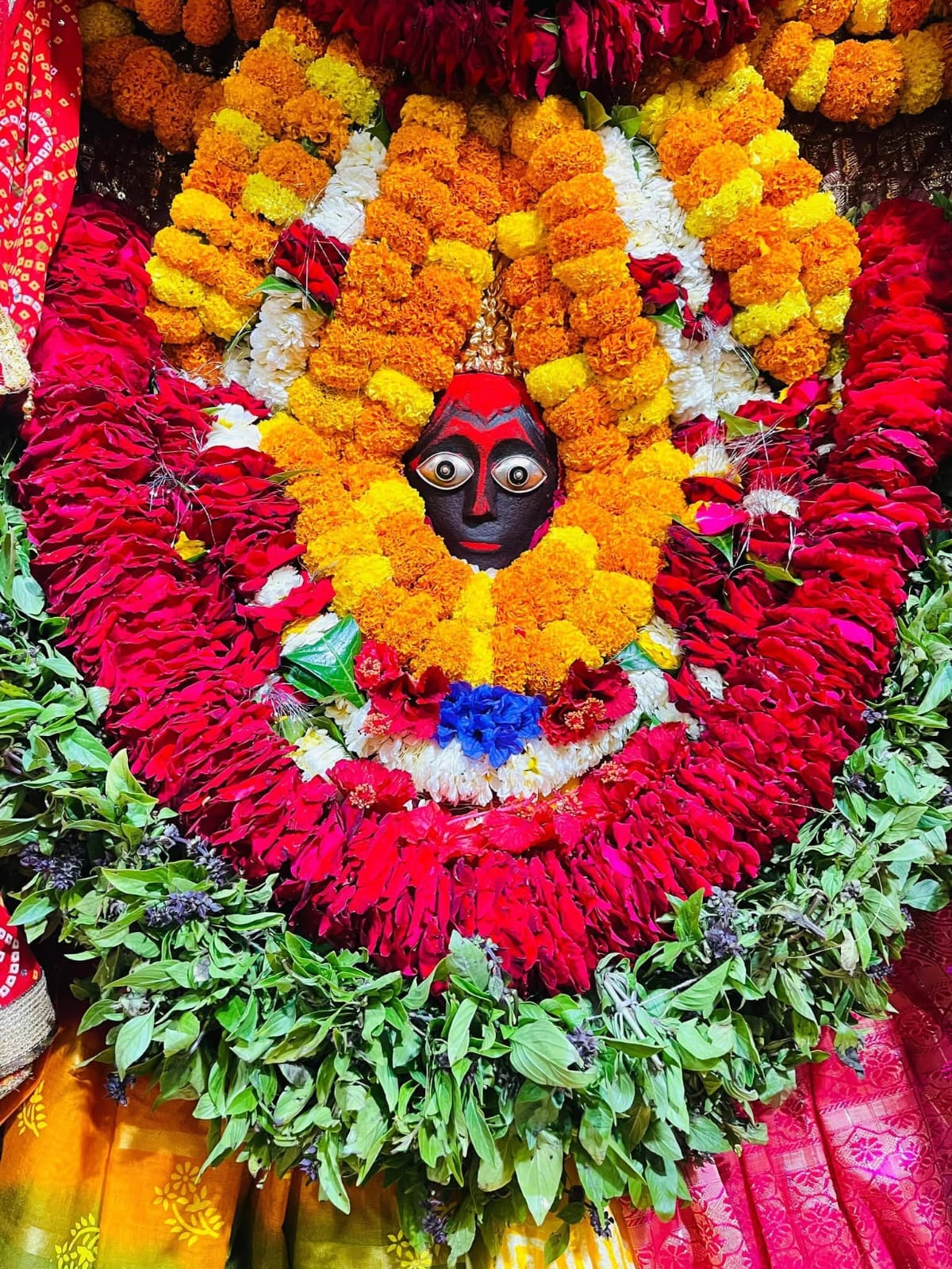 Mother's adornment with red, yellow and green chunari