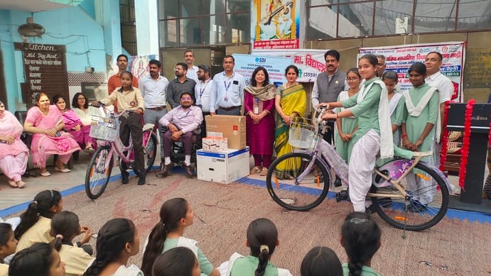 Girl students receive bicycles at the Government Senior Secondary School.
