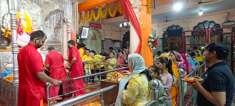 Devotees throng temples for *darshan* on Ashtami; chants of victory reverberate.