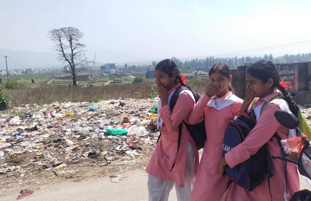 Children passing by with handkerchiefs on their noses