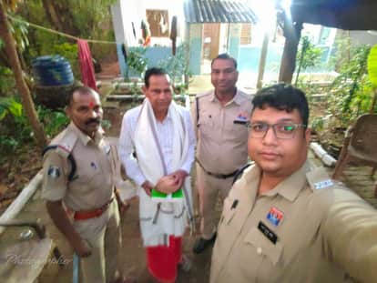 Retired police officer being honored with shawl and coconut . Friends and family gathering to congratulate him