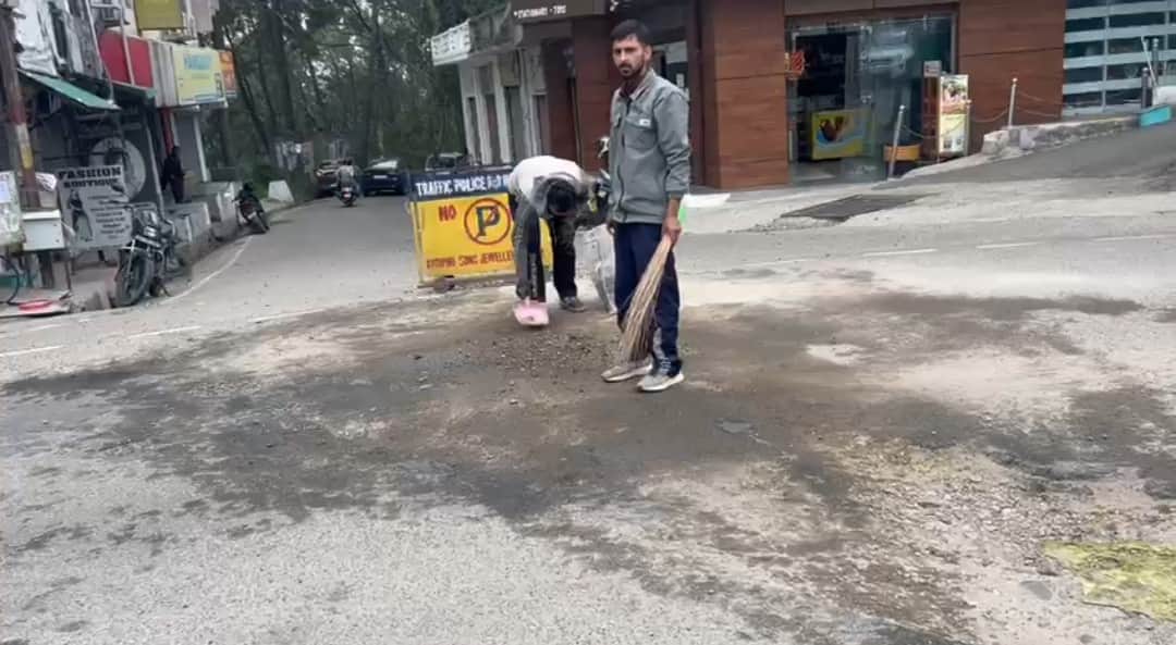 हीरानगर सड़क में बने गड्ढों को मिट्टी से भरते युवा। स्रोत : जागरूक पाठक