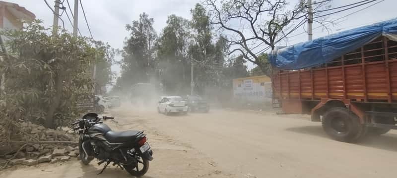 निर्माणधीन स्टेट हाइवे पर वाहनों के गुजरने से उड़ती धूल। संवाद