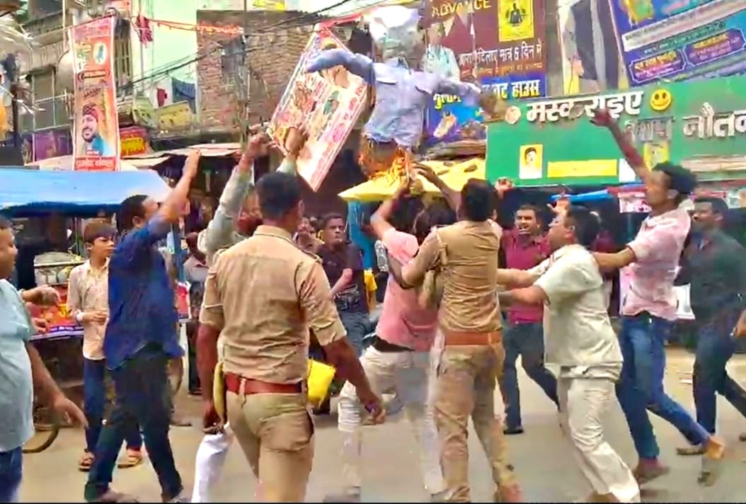 Scuffle ensues between protesters and police when they are prevented from burning an effigy.