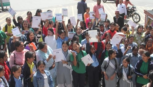After the exam results, the girl students took to the streets with their report cards to protest the disease.