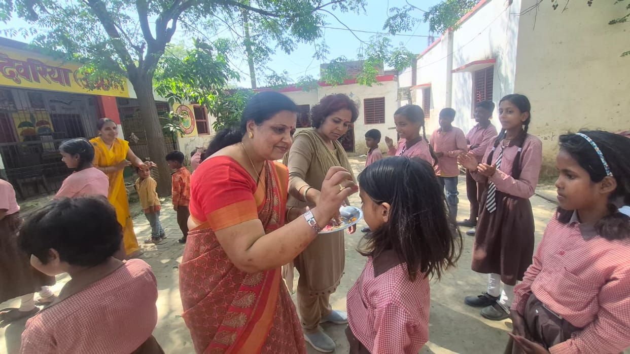 Children were welcomed in schools by applying tilak and showering flowers.