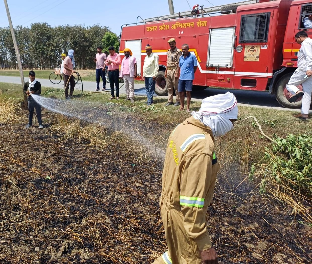 A short circuit in a high-tension line caused a fire in a field, which villagers brought under control.
