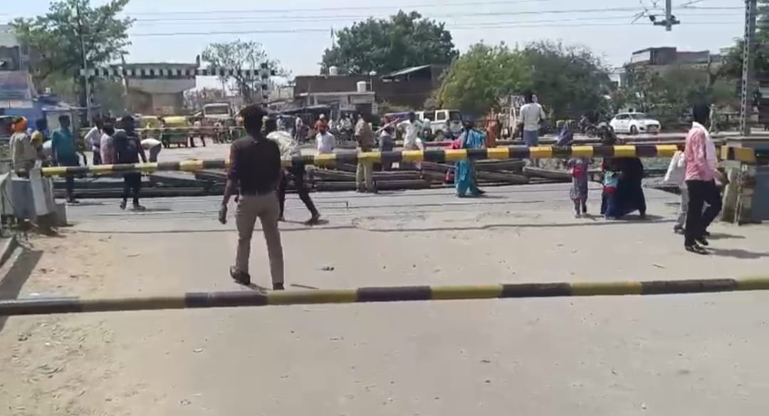 Railway gate remained closed, women walked in the sun with children in their lap