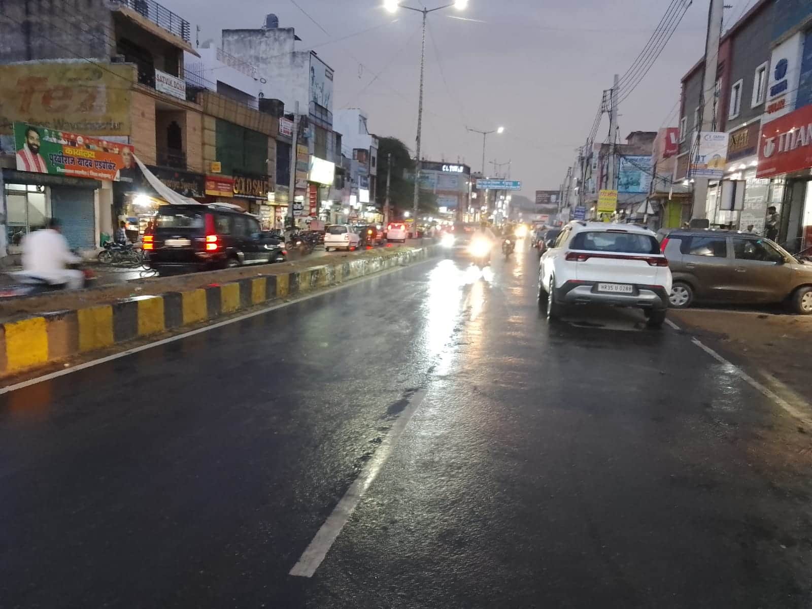 फोटो नंबर- 22नारनौल में देर शाम हुई बूंदाबांदी के दौरान सड़क से गुजरते वाहन। संवाद