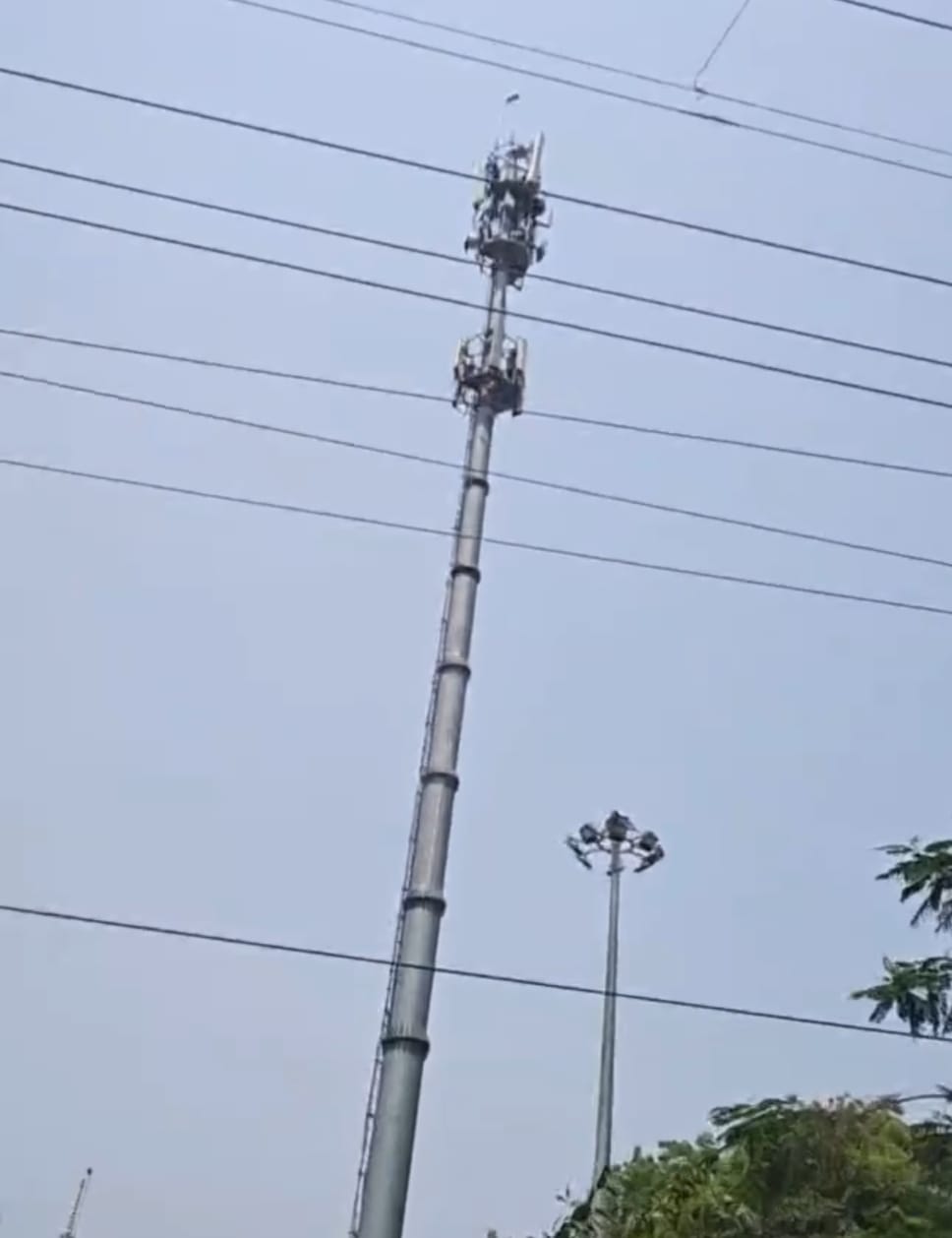 Drunk man climbs mobile tower