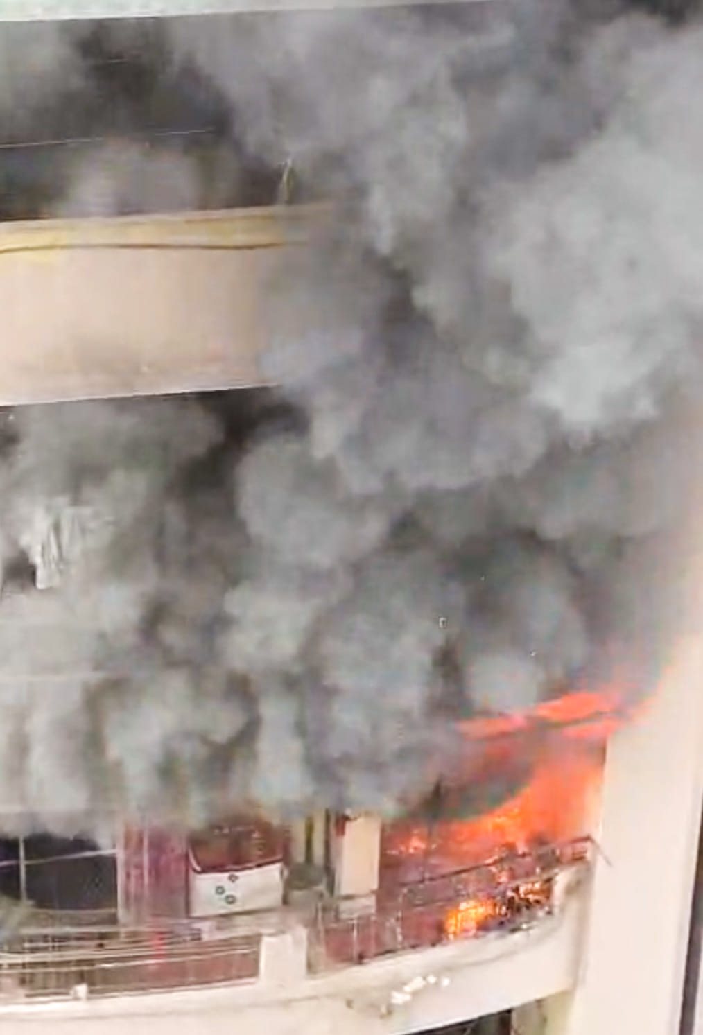 A fire broke out in three flats due to a lamp's flame, burning goods worth lakhs.