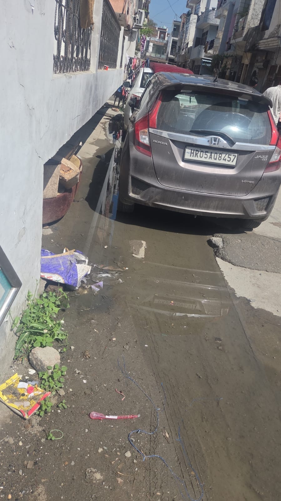 Dirty water is flowing into the streets due to leakage in the dilapidated sewerage line.