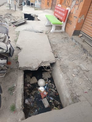 nizampur devilal chowk footpath broken slabs pedestrian hazard garbage problem