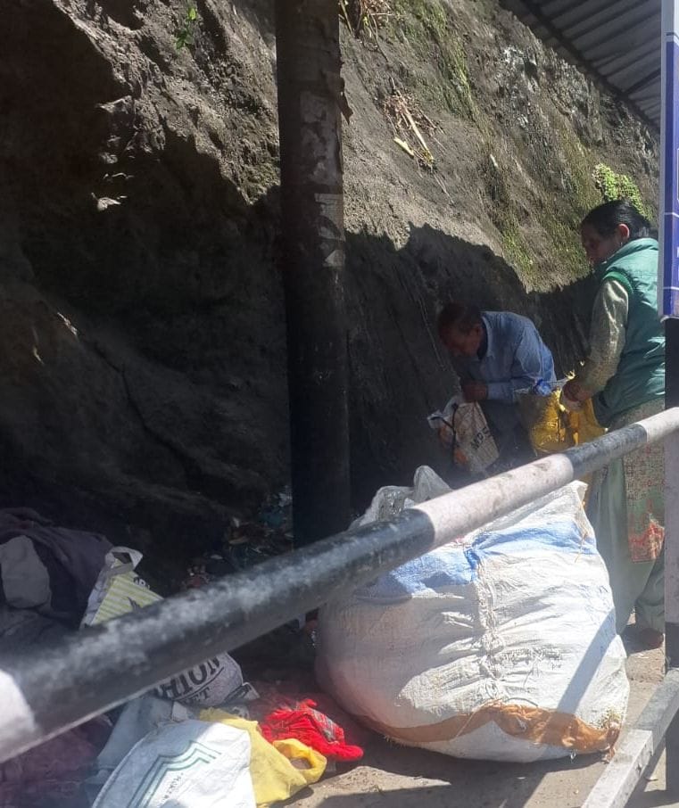 Sanitation workers collecting garbage without masks and gloves