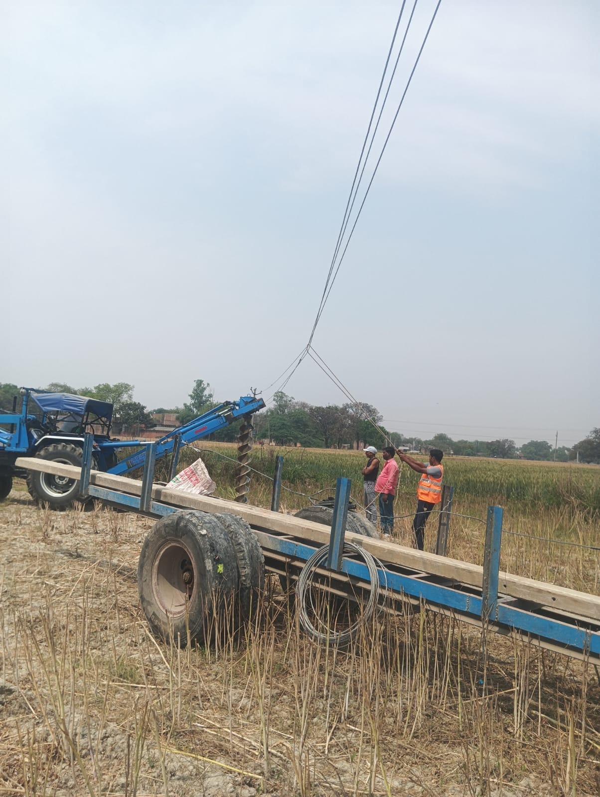 The department repaired loose high-tension wires hanging over wheat fields.