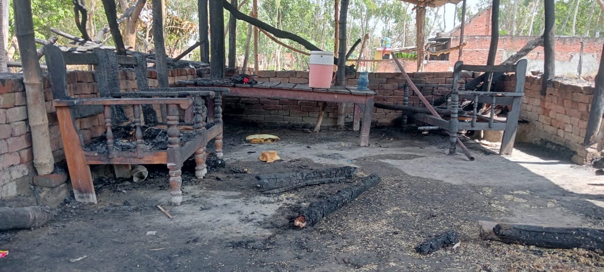 Two people were burnt and 12 goats died in a hut fire.