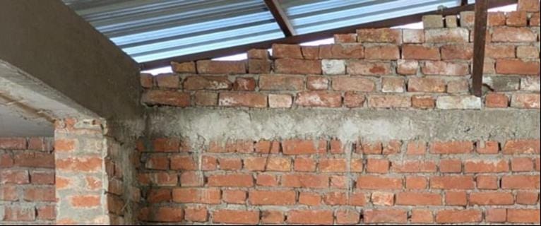 The beams of the composite school rooms are heavier, supported by brick columns