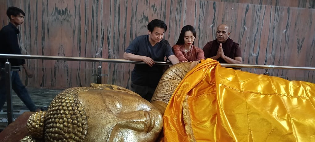 Japanese Tourists Offer Robes to the Buddha and Pray for World Peace.