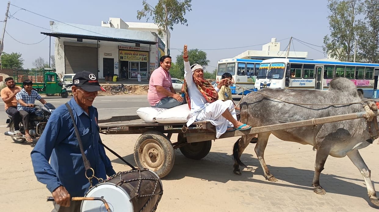 A farmer arrived at the market with his harvest in a bullock cart, accompanied by a drum.
