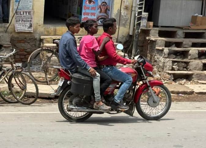 ज्ञानपुर नगर में बिना हेलमेट जा रहे एक बाईक पर तीन सवार। संवाद