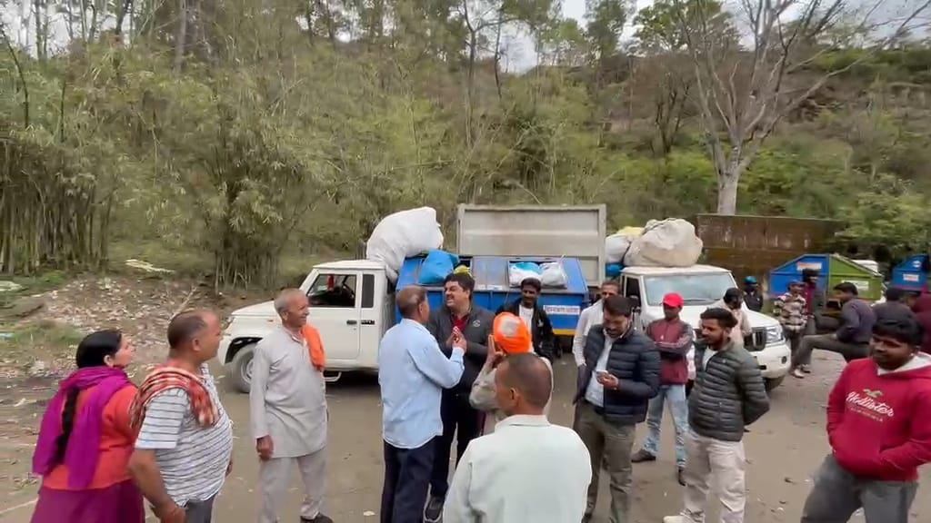 Protest against garbage being overturned in a vehicle outside the dumping site