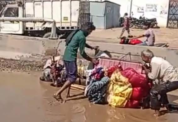 E-rickshaws and bike riders fell into water-filled potholes on the highway.
