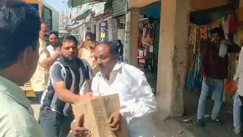 Uproar over removal of goods; scuffle breaks out between shopkeepers and staff.