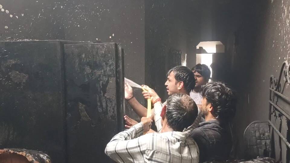 A flame set the house on fire, and the family escaped by climbing down to the roof.