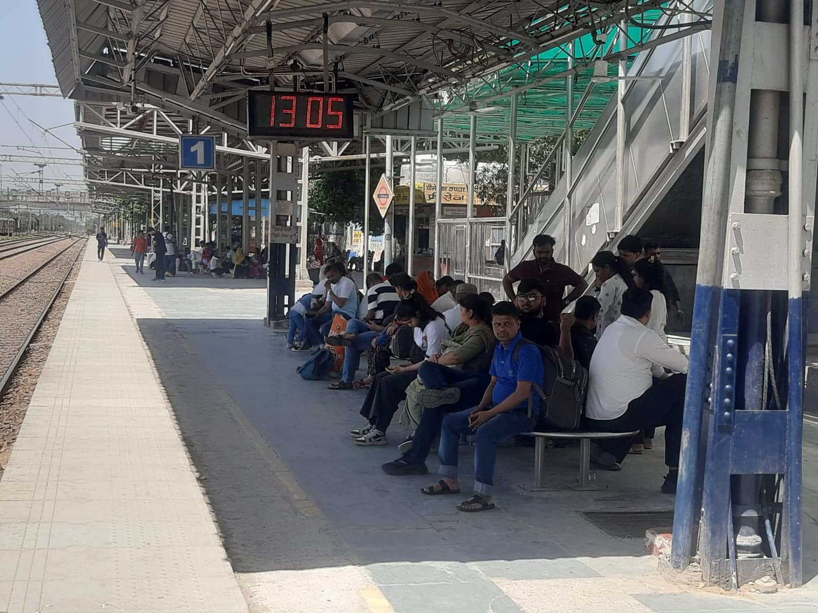 फोटो: सोनीपत रेलवे जंक्शन पर ट्रेन आने के इंतजार में बैठे यात्री। संवाद