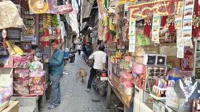 दुकान बाहर लगाने के कारण गली संकरी हो गई है। संवाद