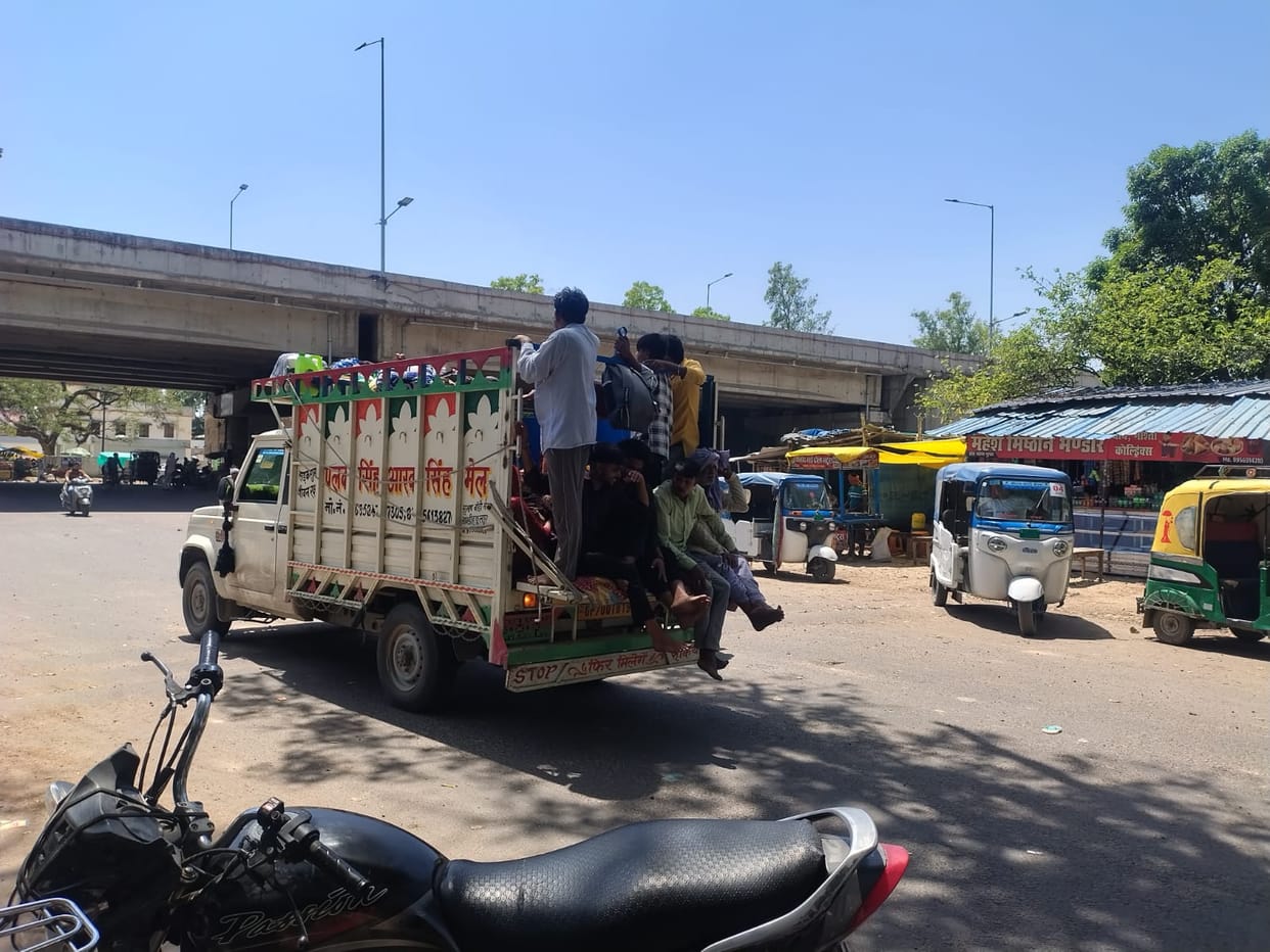 Tractors and pickup vehicles are speeding with overloaded passengers.
