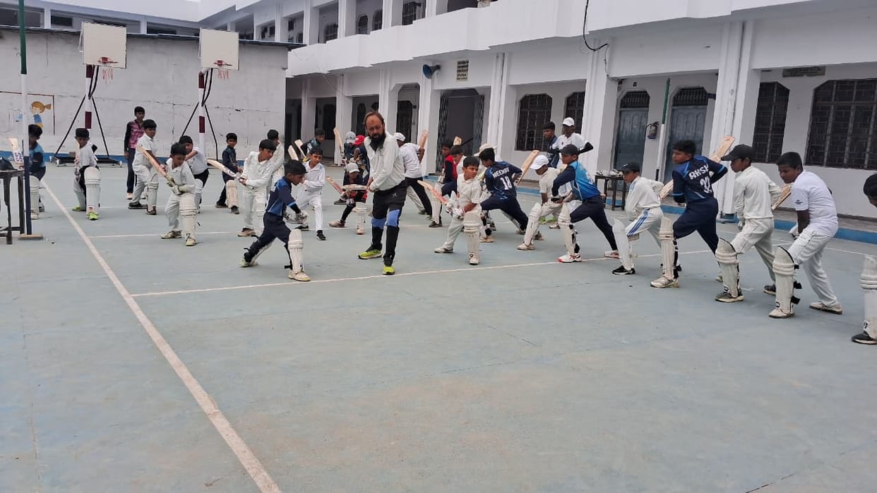 Children learn the tricks of cricket in the camp