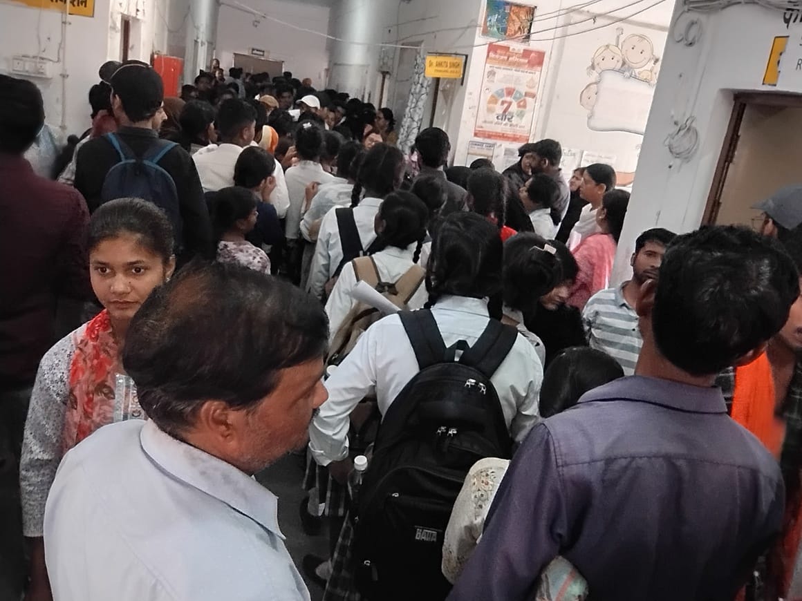 As the crowd of students and parents swelled, the main gate was closed, and they were instructed to obtain tokens.