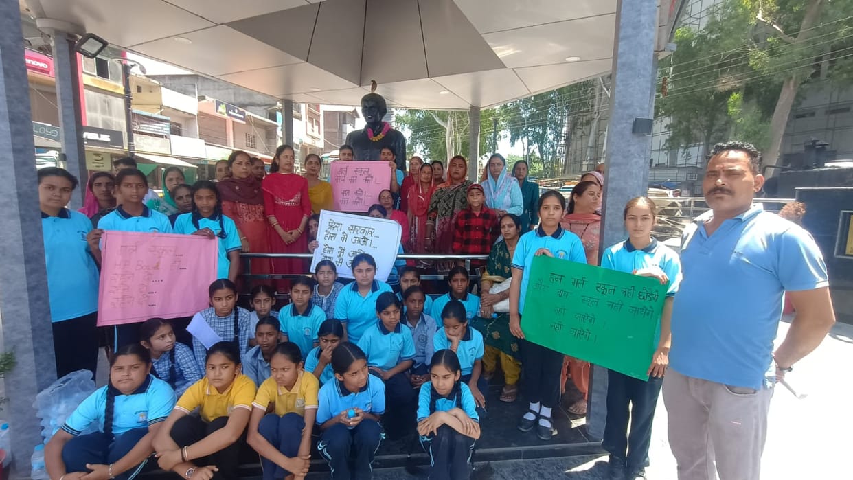 Girls along with their parents staged a sit-in protest against the merger of Nadaun Girls School.