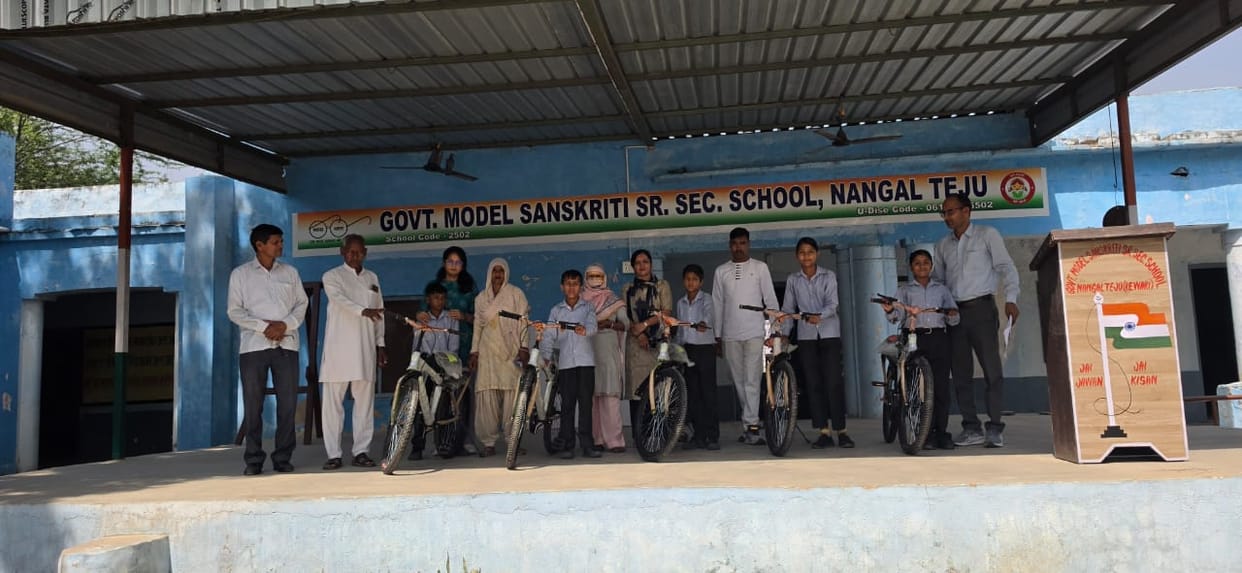 Bicycles distributed to students, smiles on their faces