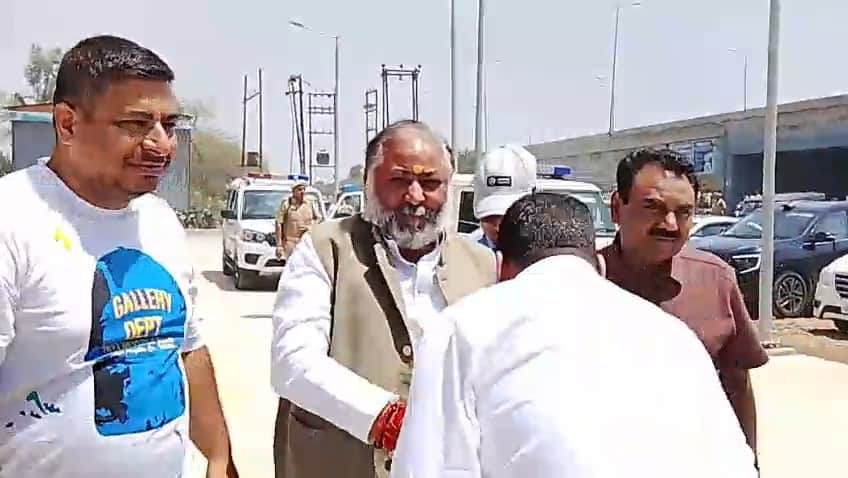 परिवहन मंत्री के पैर छूने के लिए झुकते एआरटीओ प्रशासन सर्वेश सिंह।