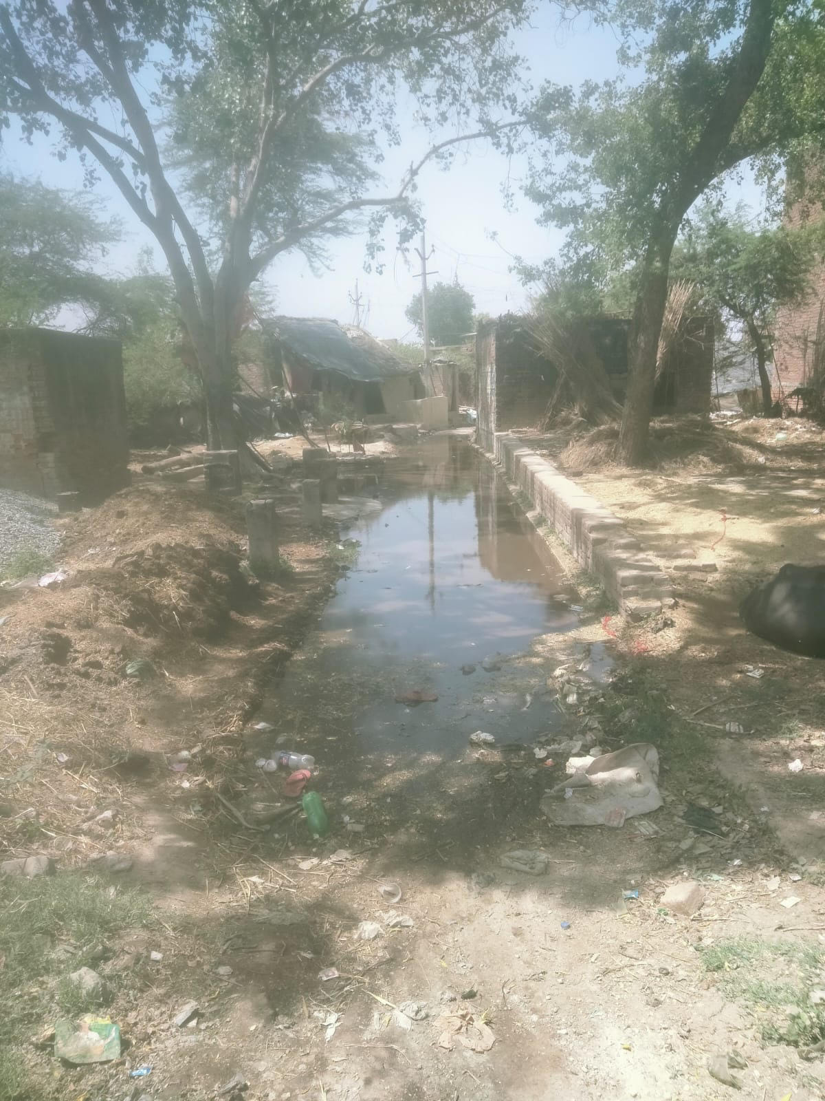 Drain water filled the road in Jogi Dera village