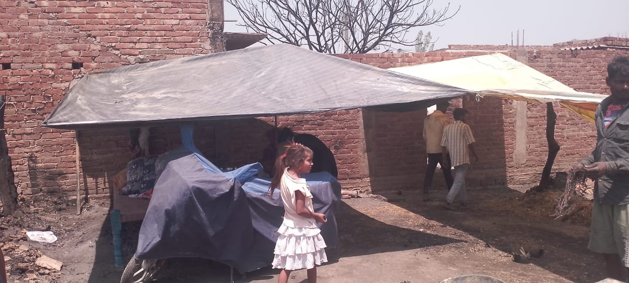 Homes gutted by fire, life under tarpaulin