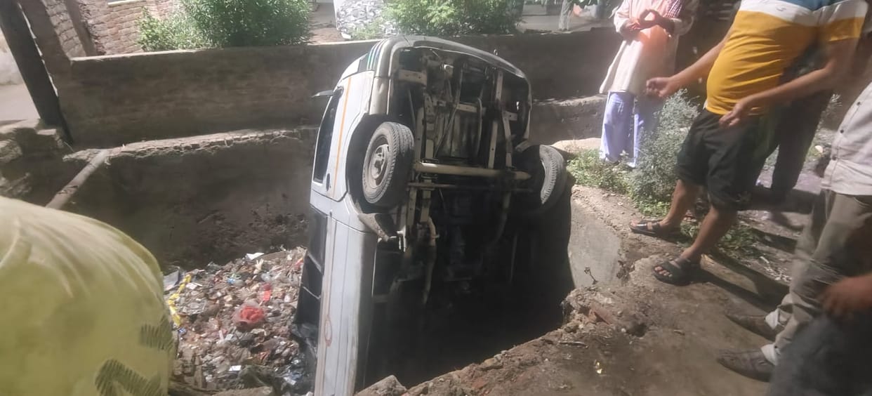 The van fell into the drain while backing up.